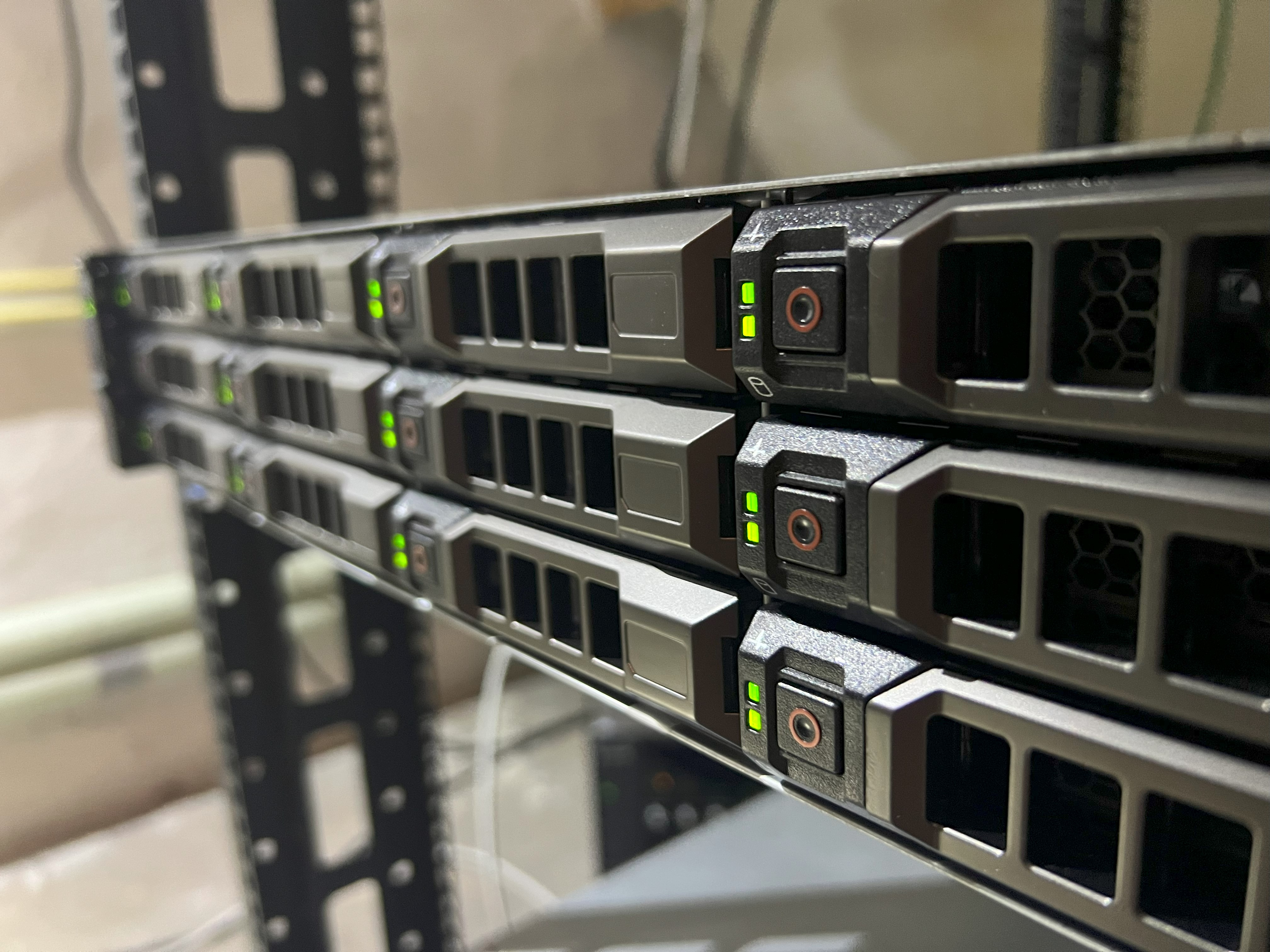 Close-up view of a rack-mounted server with active status LEDs in a data center or server room.
